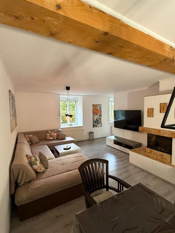 a living room with a couch and a tv at Ferienwohnung Nora in Vordernberg