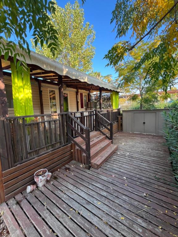 a home with a wooden deck with a house at VI05 Village 05 in Vias