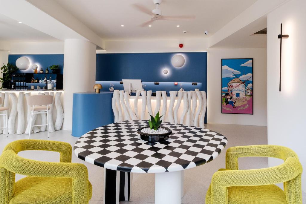a dining room with a checkered table and chairs at Noera in Skiathos
