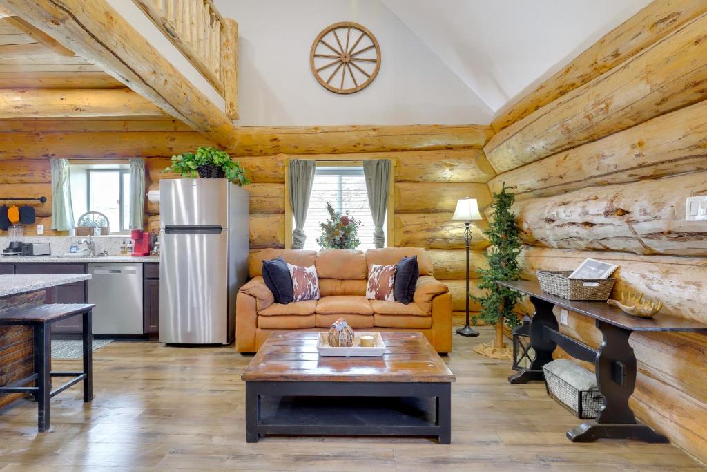 a living room with a couch and a kitchen at 'Rustic Cliff Ranch' in Uintah Basin: Dogs Welcome in Fort Duchesne