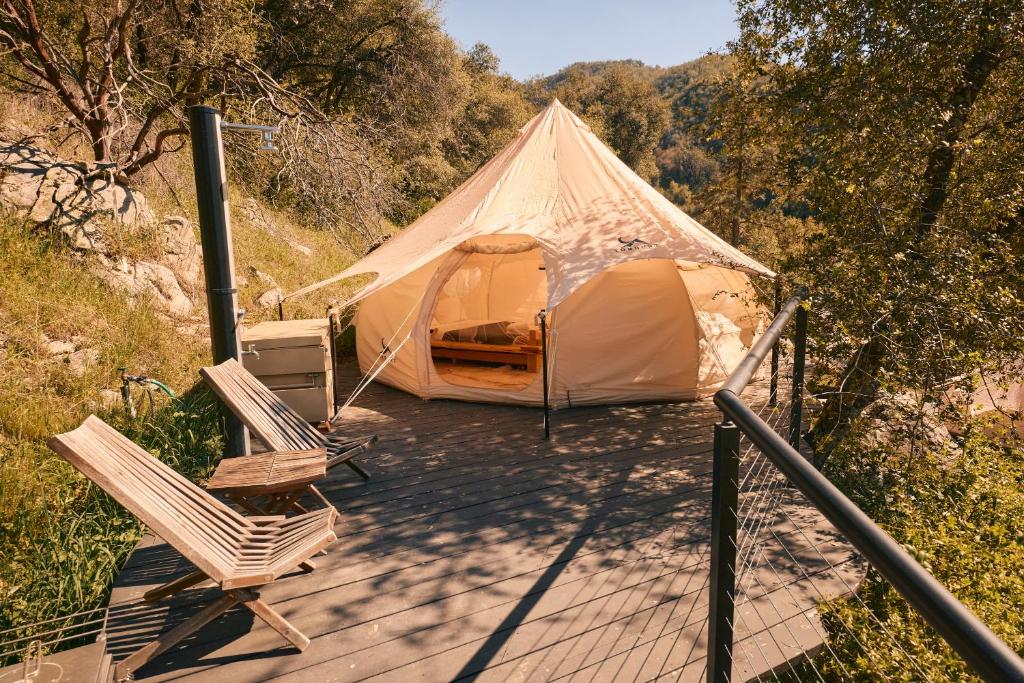 a tent and two chairs on a wooden deck at Paradise Ranch Inn - Mindful Tent in Three Rivers