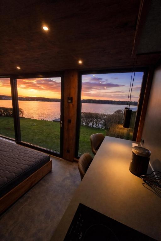 a room with a large window with a view of the water at Seechalet Kranich in Roding