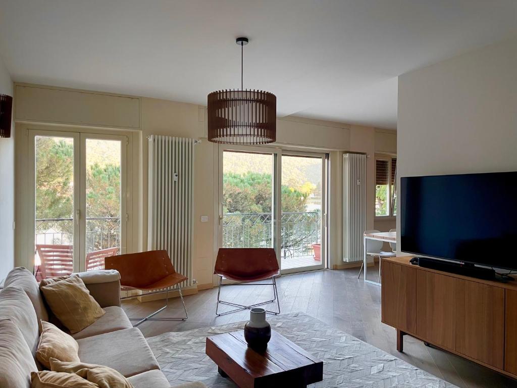 a living room with a couch and a flat screen tv at VistaLago Loft in Sarnico