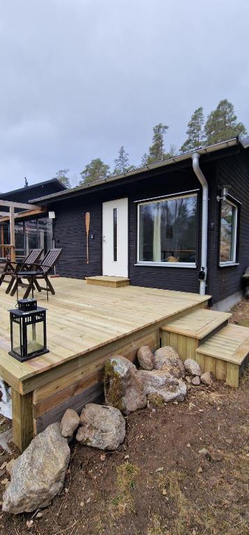 a house with a wooden deck in front of it at HavsBo in Västerhaninge