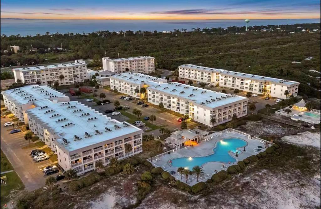an aerial view of a resort with a pool at Stay beachy in Gulf Shores