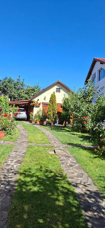 a path in a yard next to a house at Garden City Apartment in Cluj-Napoca