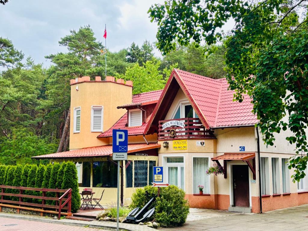 a house with a parking sign in front of it at Róża Wiatrów in Sztutowo