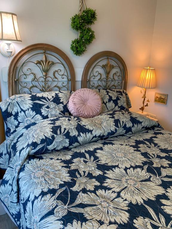 a blue and white bed with a pink pillow on it at Riverhouse Hidden Gem in The Dalles