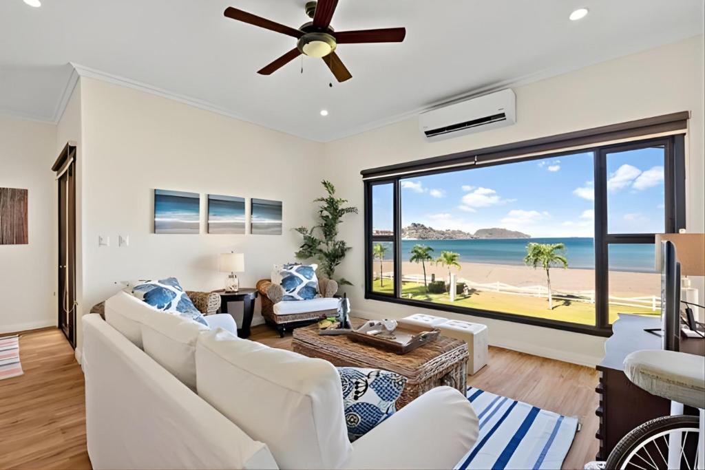 a living room with a view of the beach at Pacific Beach 9 - Beachfront Condo, BBQ, pool, prime location, sleeps 4 in Potrero
