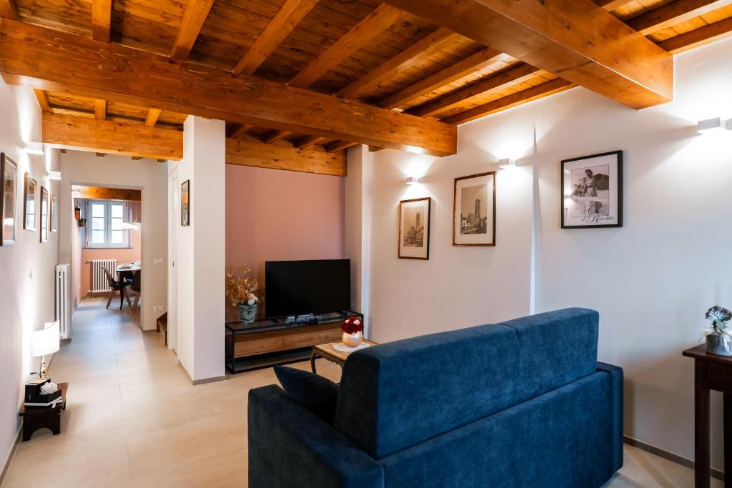 a living room with a blue couch and a tv at L'oasi di Renata in Lammari