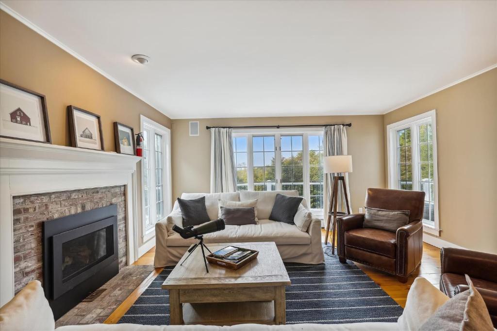 a living room with a couch and a fireplace at Mill Lane in Stowe