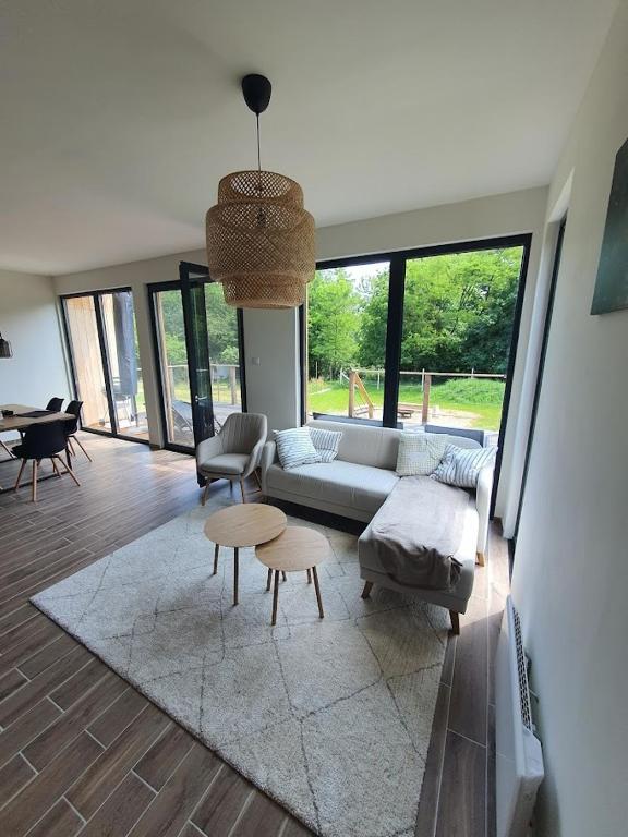 a living room with a couch and a table at Ohuta-Barn Vendégház in Parád
