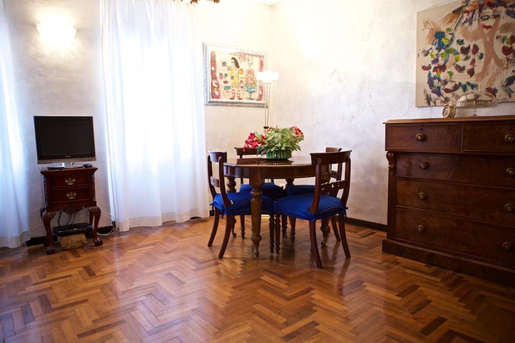 a dining room with a table with chairs and a television at La Casetta di Zio Mario in Rome