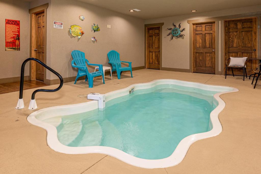 a hot tub in a room with chairs and chairs at Hilltop Haven in Gatlinburg