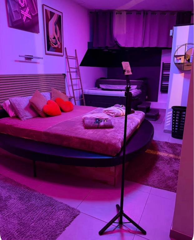 a bedroom with a bed with purple lighting at Liberty walk in Montmorot