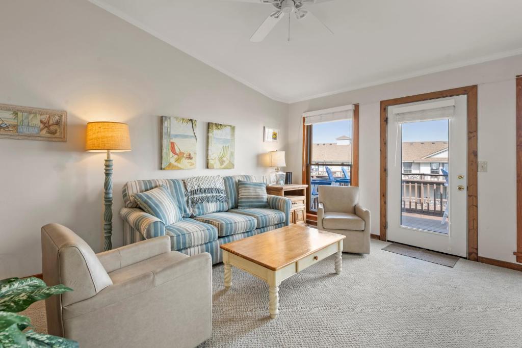a living room with a couch and a table at Ocean Views From Every Room in Kitty Hawk