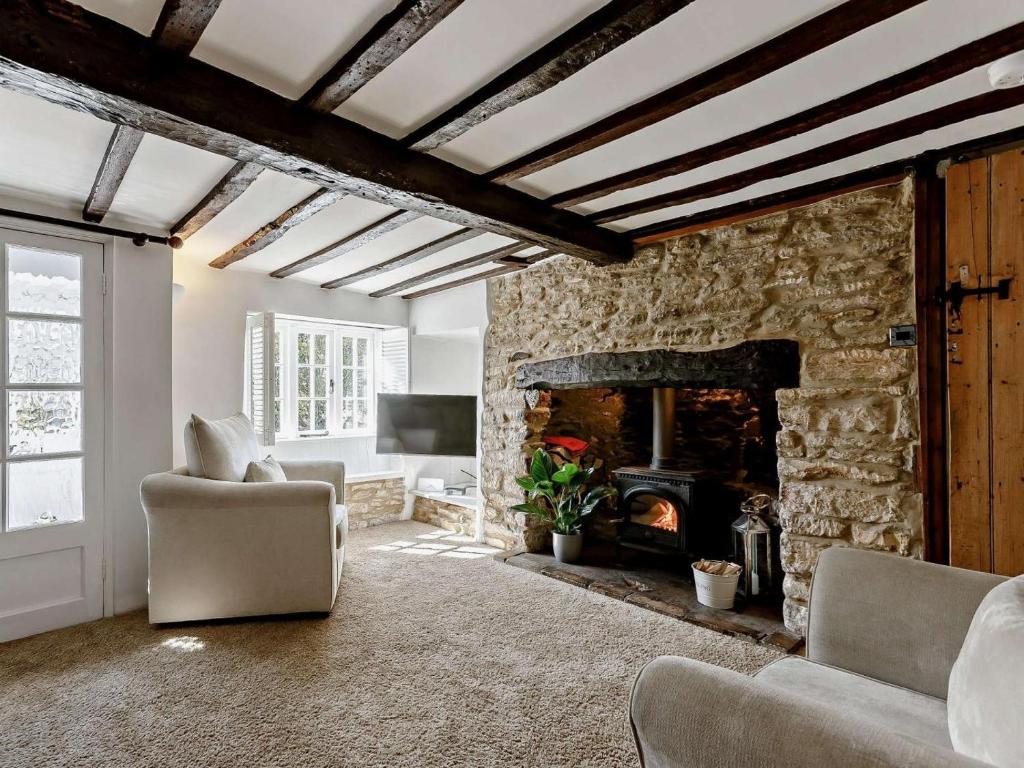 a living room with a stone fireplace at 3 Bed in Witney oc-82478 in Hailey