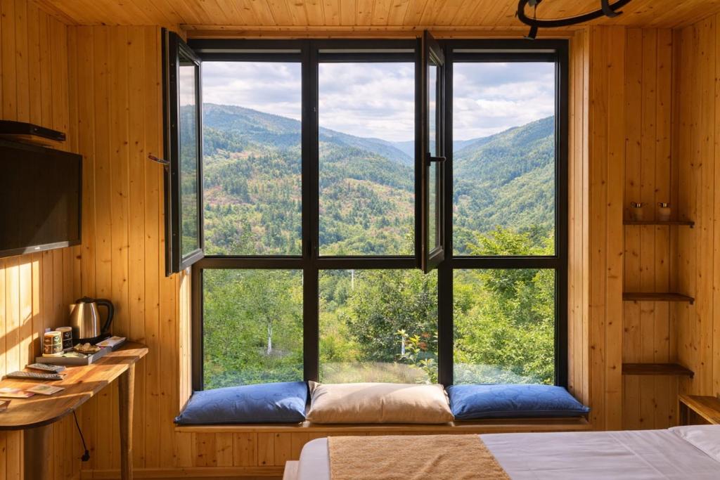 a window in a room with a view of the mountains at Chateau Chao in Khulo