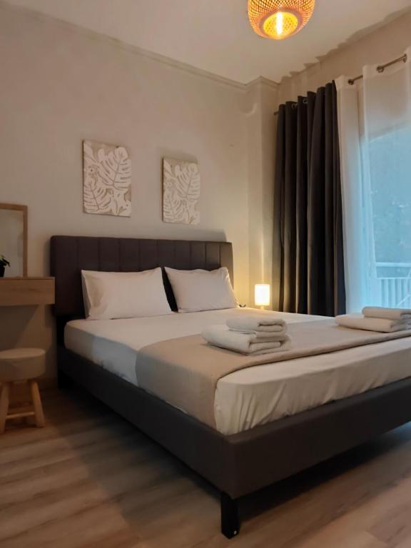 a large bed in a bedroom with a window at house blue sea in Iraklitsa