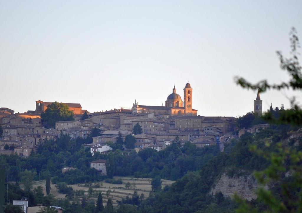 una città in cima a una collina con un edificio di Hotel La Meridiana a Urbino