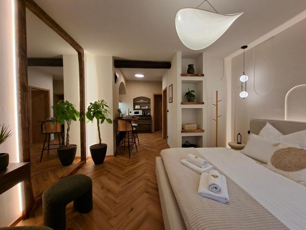 a bedroom with a bed with two towels on it at Old Town Living Studio in Český Krumlov