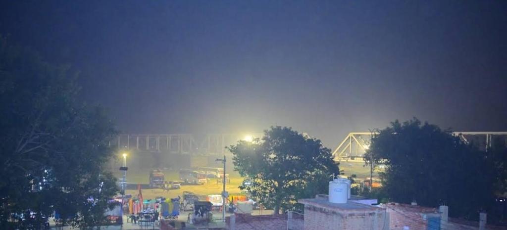 a foggy city at night with a parking lot at Abhishek chand kaushik guest House in Ayodhya