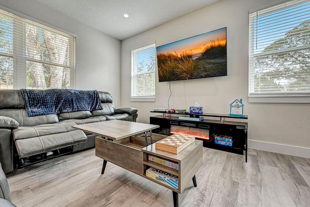 a living room with a couch and a table at 1mi to Downtown! 3BR6BedsScreenroom,Deck,Firepit in St. Augustine