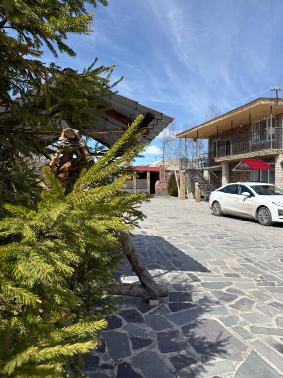 a christmas tree in front of a building at Vibe Hotel Vanadzor in Vanadzor