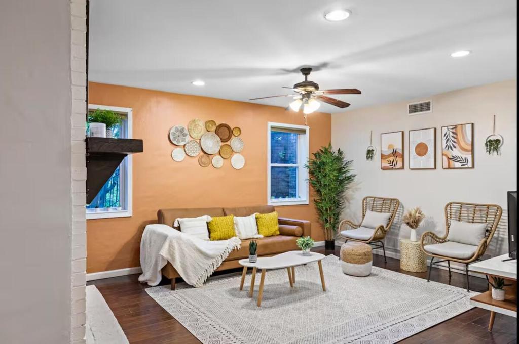 a living room with a couch and a ceiling fan at Sun-Filled and Spacious One-Level Buckhead Oasis in Atlanta