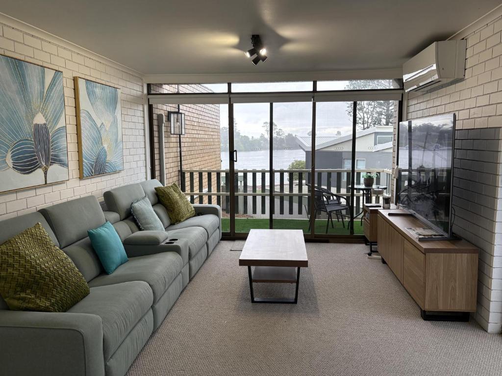 a living room with a couch and a table at Water Views Nagambie in Nagambie