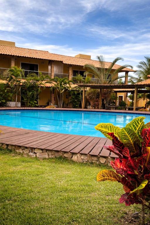 a swimming pool in front of a resort at Pousada Refugio Jardim de Canoa in Canoa Quebrada
