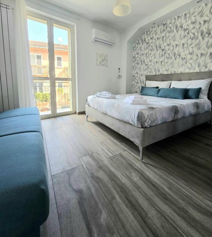 a bedroom with a large bed and a large window at B&B Fede e Natura in Caposele