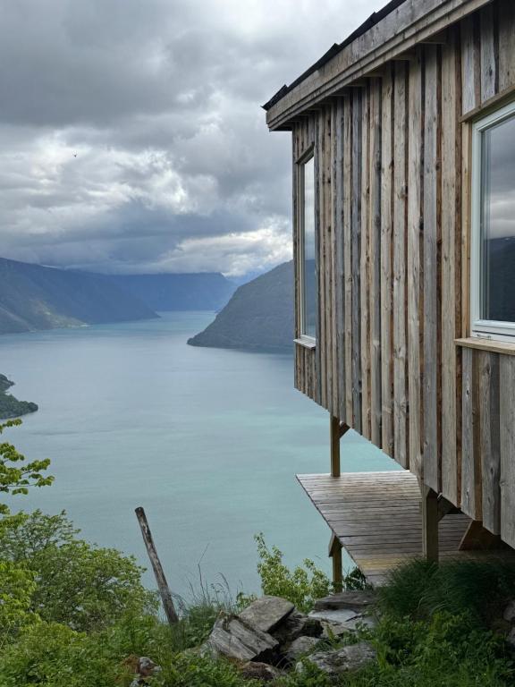 a cabin with a view of a lake at Raaum Gard, hytte 3 in Luster
