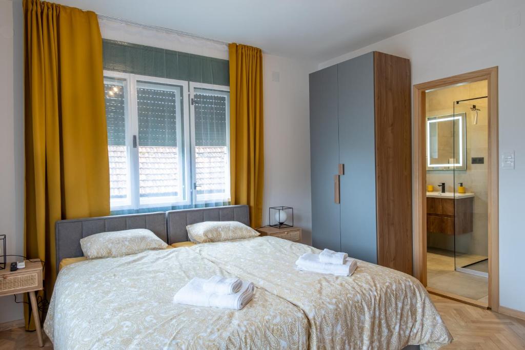 a bedroom with a bed with two towels on it at OPG Kuzmanović in Goljak