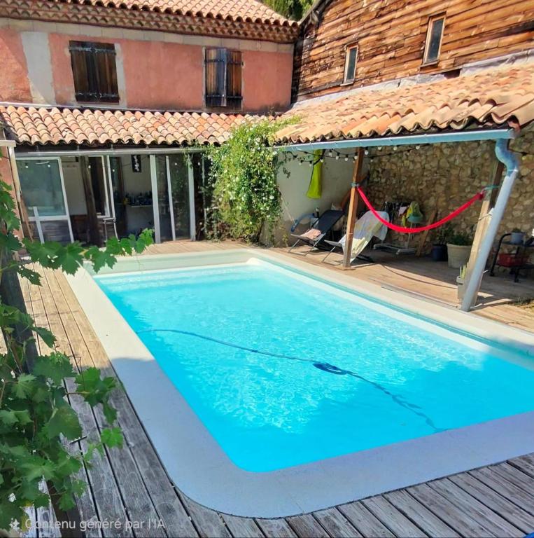a swimming pool in the backyard of a house at La Farigoulette in Aniane