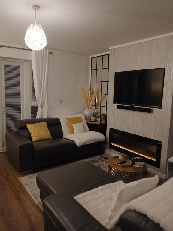 a living room with a couch and a fireplace at Anchored Homes in Spalding