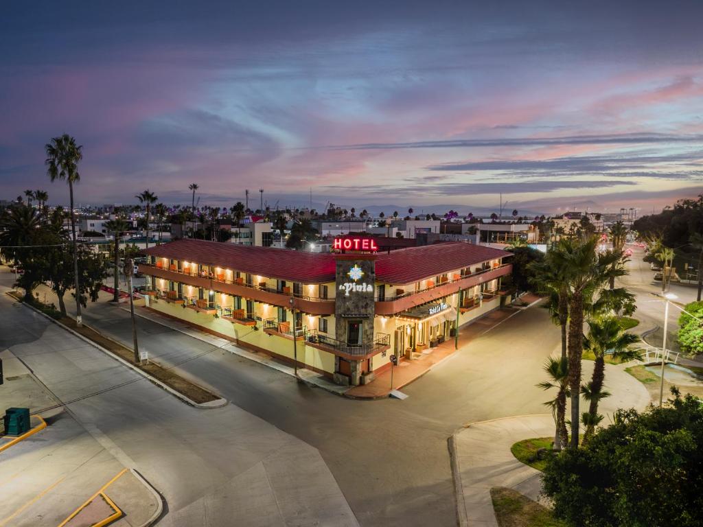 a building with a neon sign on top of it at La Pinta Hotel in Ensenada