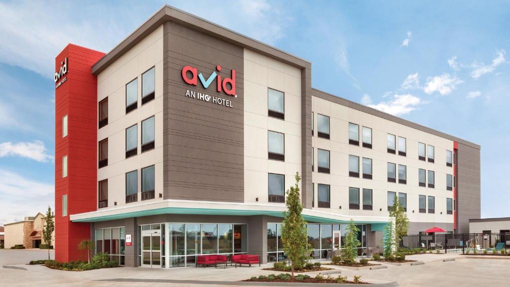 an office building with a sign on the side of it at avid hotel Redding by IHG in Redding