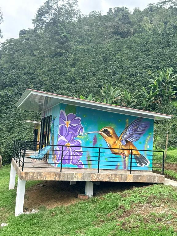 a building with a painting of a bird on it at Cabañas Agroturistica la Polkca - Experiencia Cafetera in Líbano