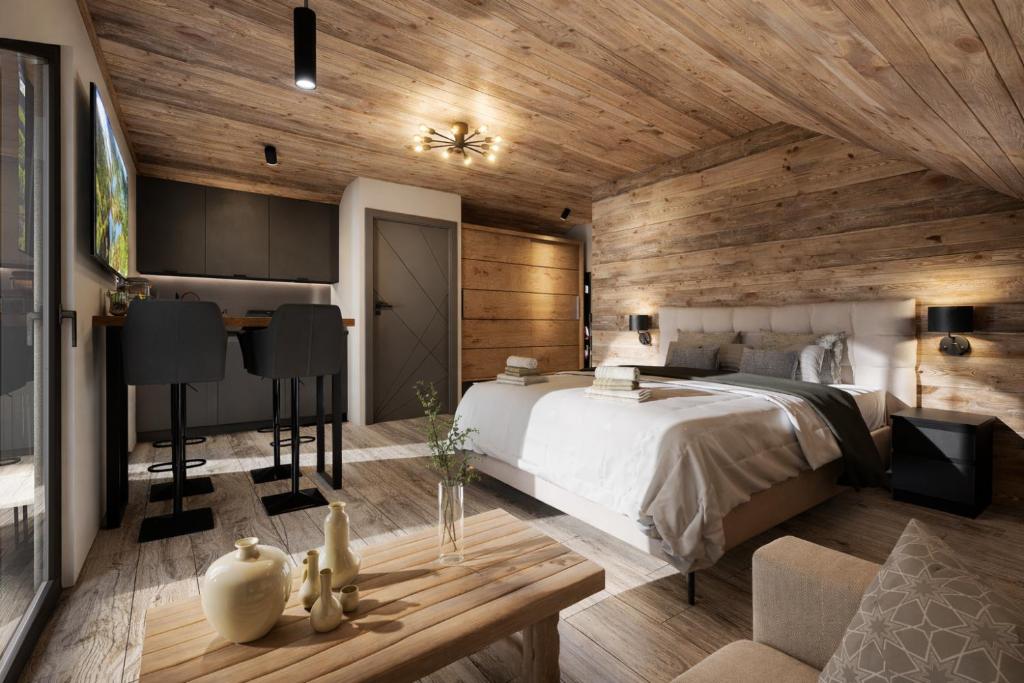 a bedroom with a bed and a wooden wall at ELAFON Lodge in Kolašin