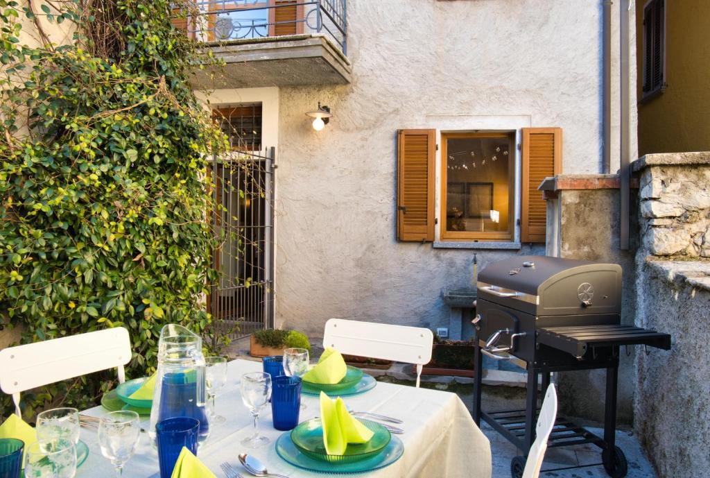a table with a bbq on a patio at Authentic Lake Como Home near Bellagio in Limonta
