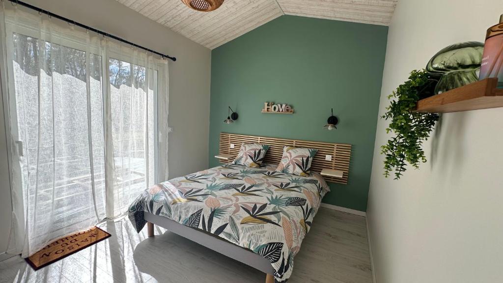 a bedroom with a bed and a large window at Chambre spacieuse et moderne in Sallertaine