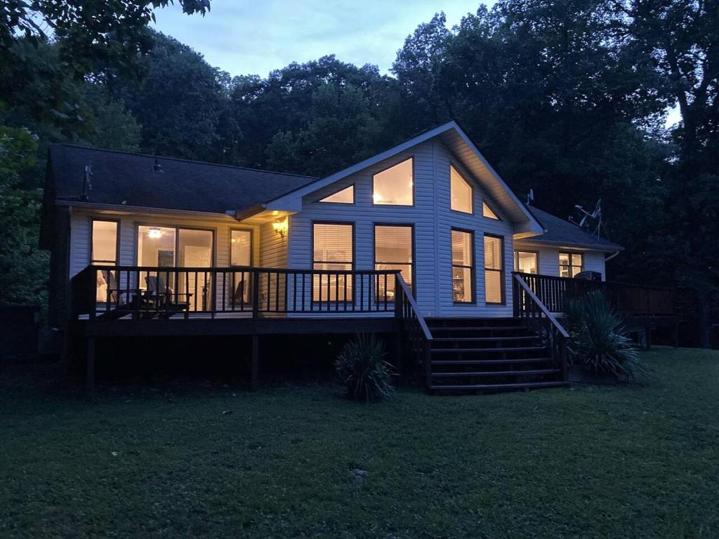 a small house with a large porch and a deck at Hidden Shores in Big Sandy