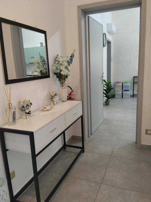 a bathroom with a white dresser and a mirror at Carolina's Bedrooms in Trapani
