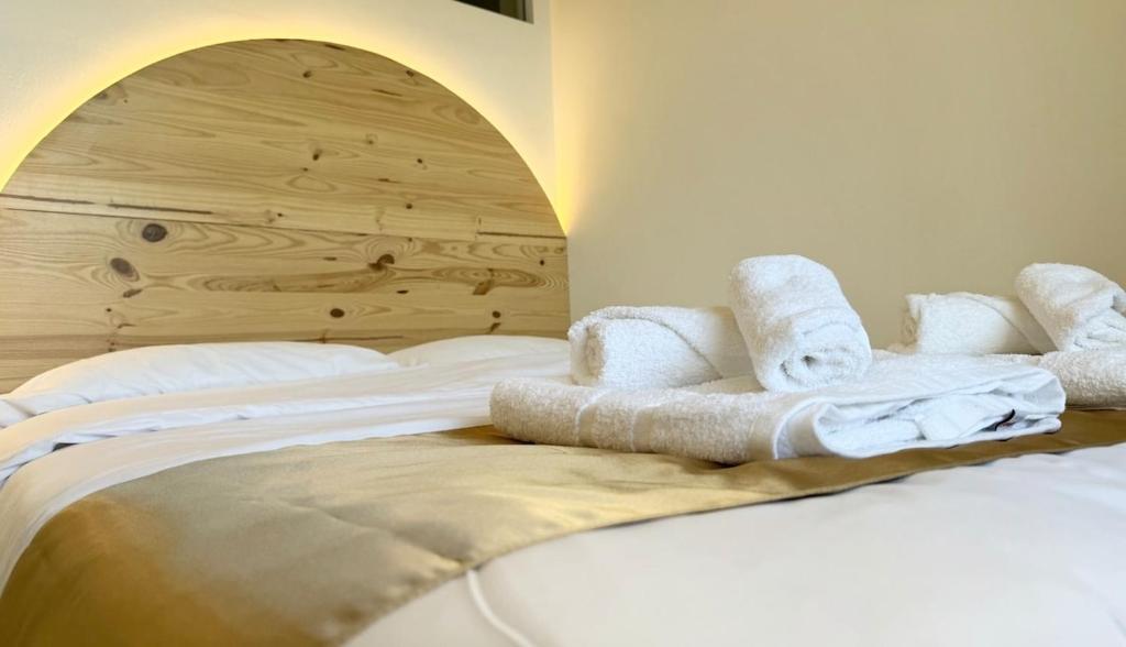 a bedroom with white towels on a bed at ZELUN Suite Torremolinos Center in Torremolinos