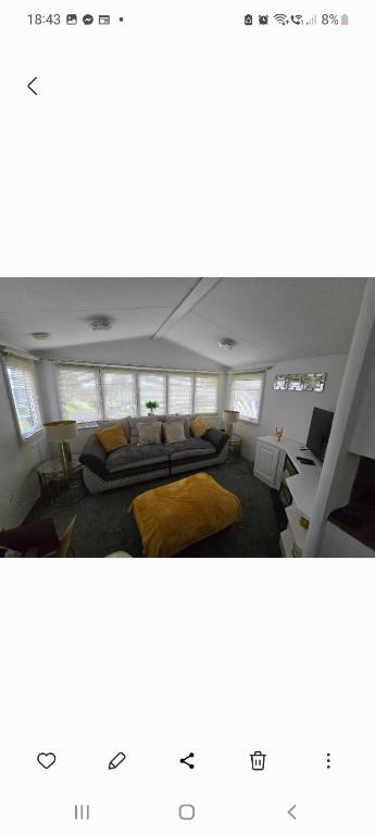 a bedroom with two beds in a room with windows at 68 Lochview in Stranraer