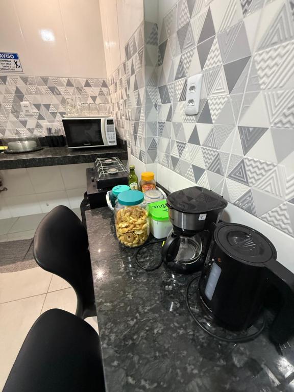 a kitchen with a counter with a coffee maker and food at 2367 Belém Residence in Belém