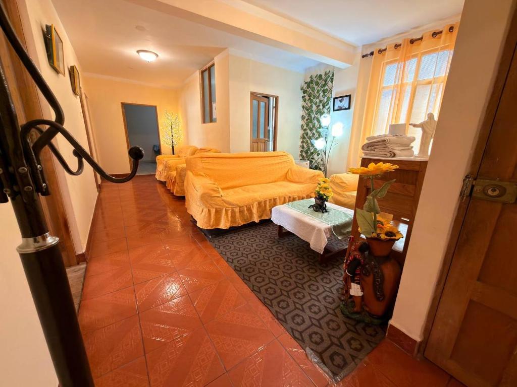 a living room with two beds and a table at Central Stay Departamentos I - Camacho in Oruro