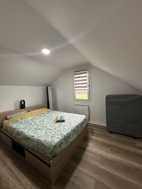 a bedroom with a bed with a stuffed animal on it at Pure comfort in Entrelacs
