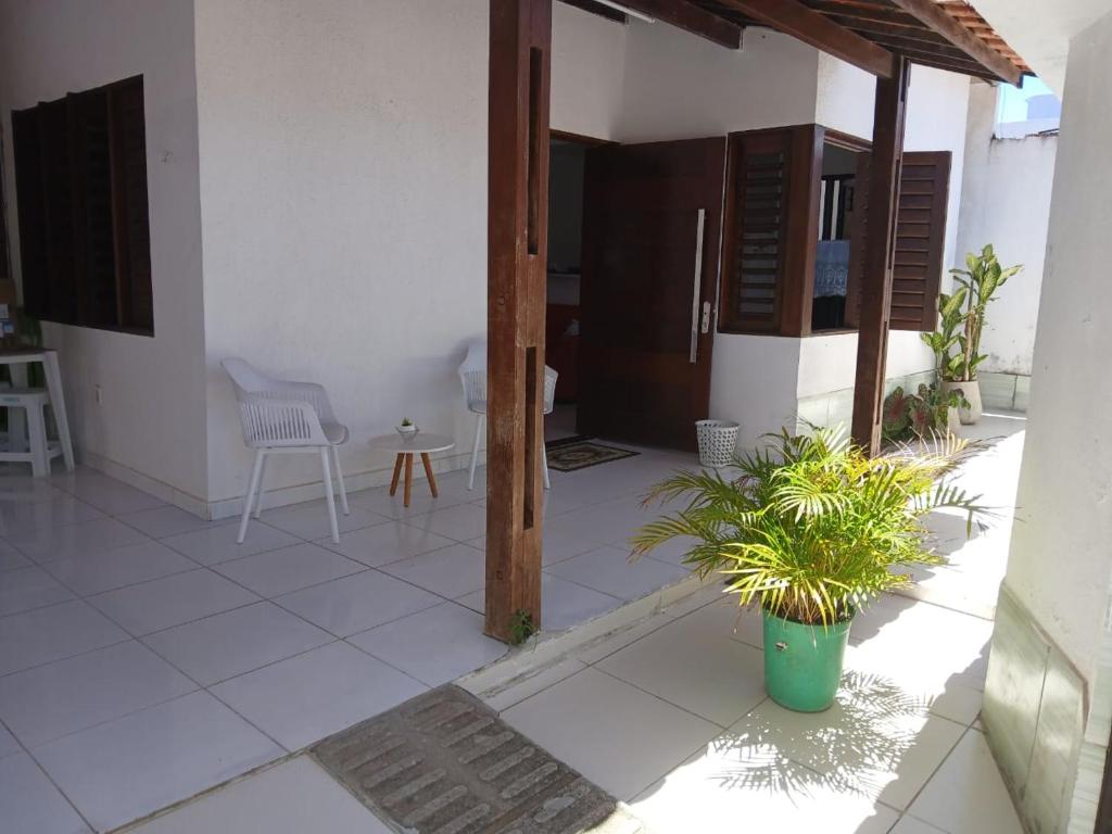 a room with a patio with a table and chairs at Casa praia de Barra nova 6 km de Maceió in Marechal Deodoro